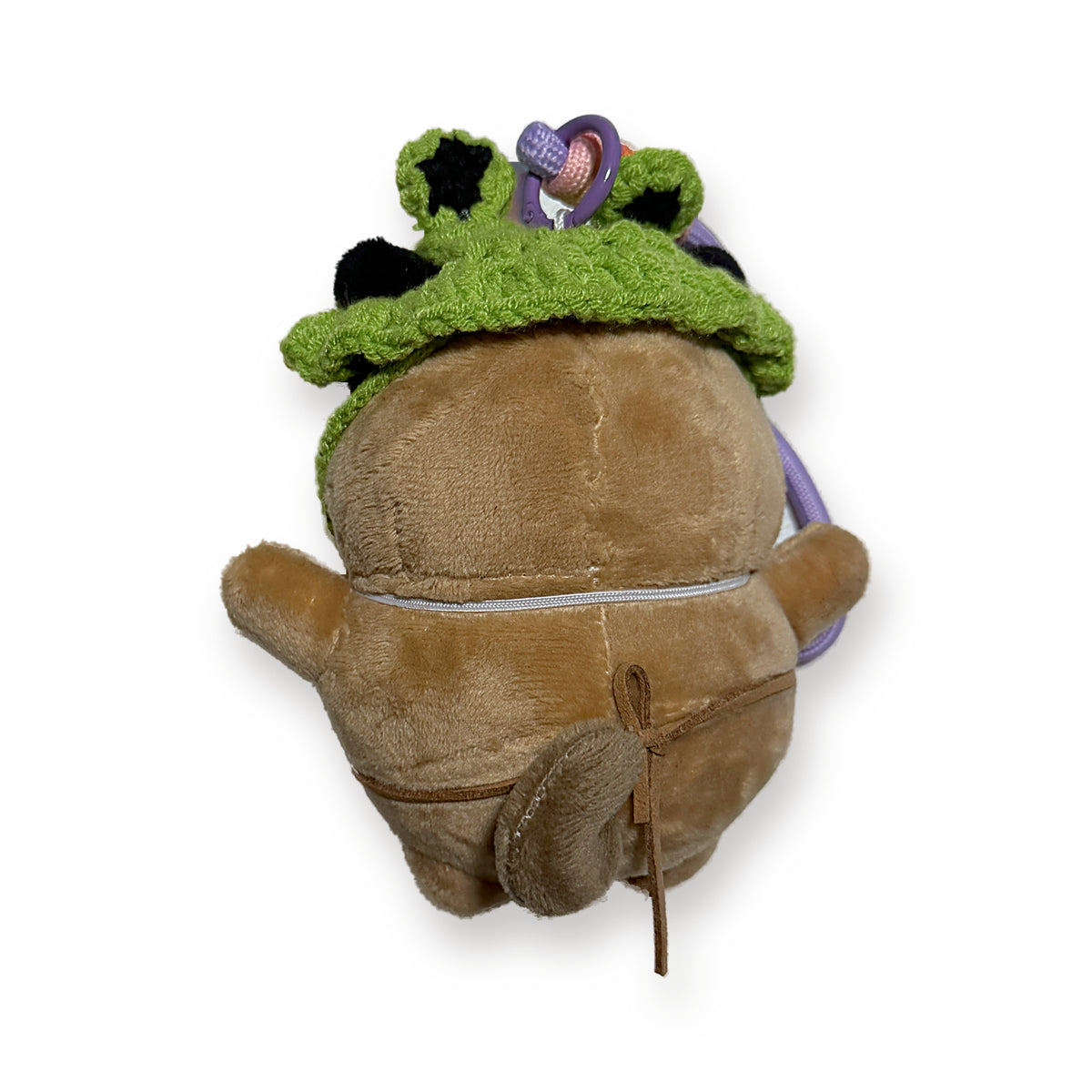 PUUG pug plush bag charm in a green frog beanie, top view showing the frog eyes